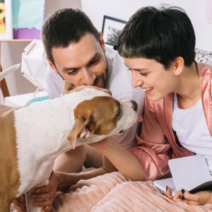 Dog owners enjoying their dog up close, with reduced allergy symptoms.